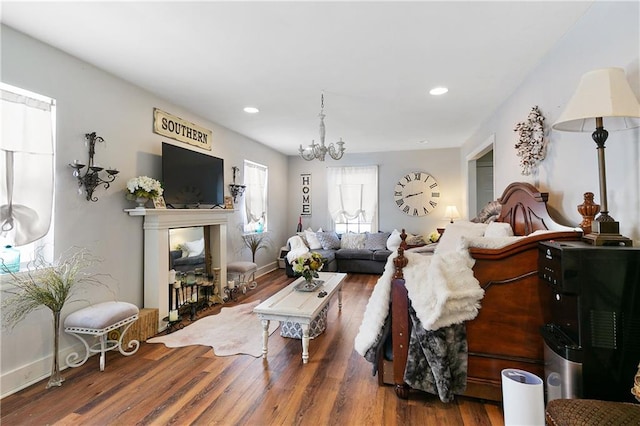 living room with a chandelier and wood-type flooring