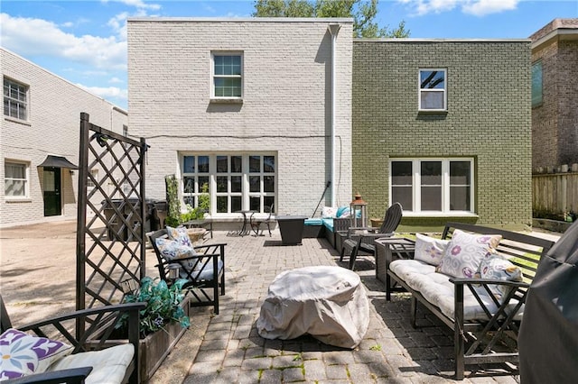 back of house with outdoor lounge area and a patio