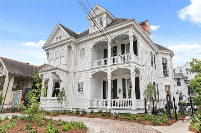 view of front of property featuring covered porch and a balcony