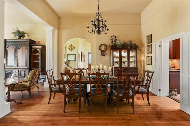 dining space with wood-type flooring and an inviting chandelier