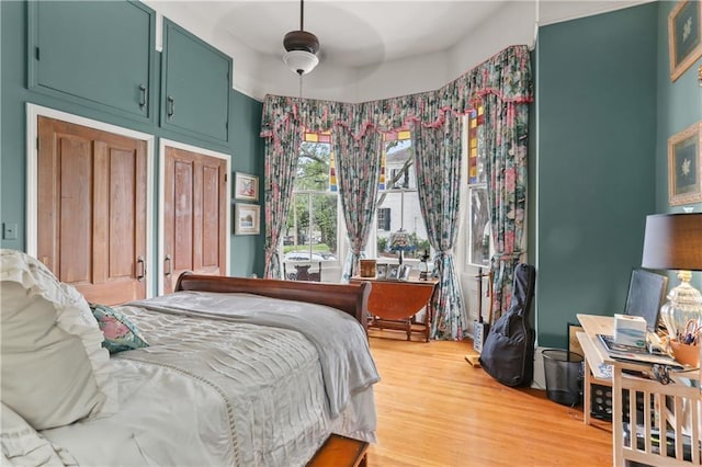 bedroom with ceiling fan and wood-type flooring