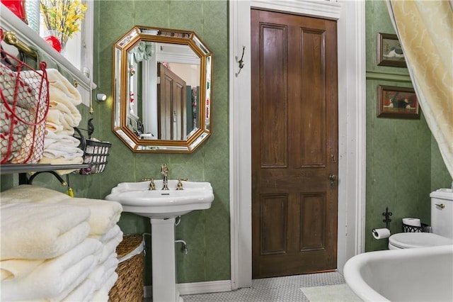 bathroom featuring tile patterned floors, toilet, and sink