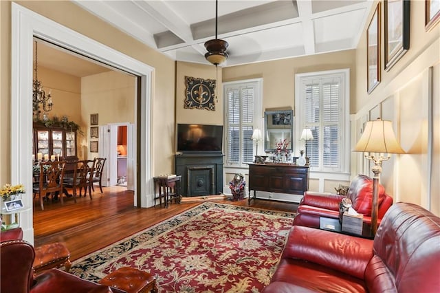 living room with beamed ceiling, ceiling fan, hardwood / wood-style flooring, and coffered ceiling