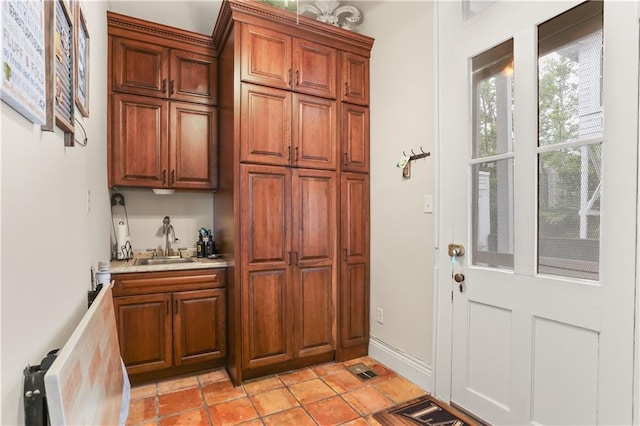 interior space featuring sink and light tile patterned floors