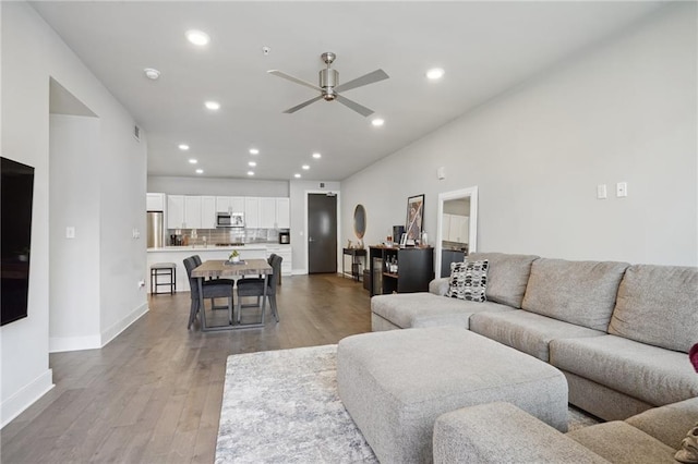 living room featuring ceiling fan and light hardwood / wood-style floors