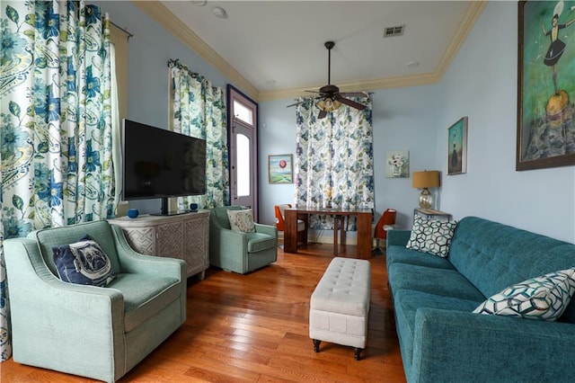 living room featuring ceiling fan, crown molding, and hardwood / wood-style flooring