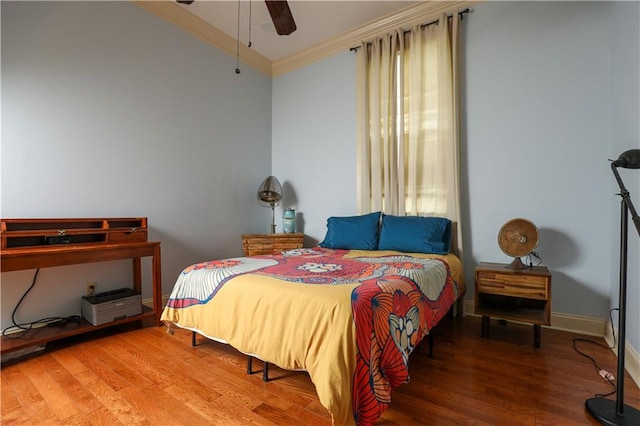 bedroom with hardwood / wood-style flooring, ornamental molding, and ceiling fan