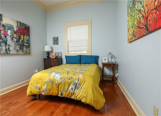 bedroom with crown molding and hardwood / wood-style flooring