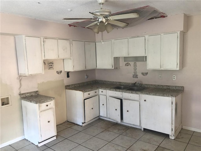 kitchen with sink, ceiling fan, light tile flooring, and white cabinetry