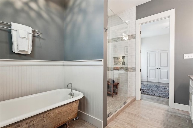 bathroom featuring shower with separate bathtub, vanity, and tile flooring