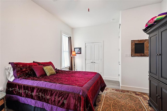 bedroom with dark hardwood / wood-style flooring