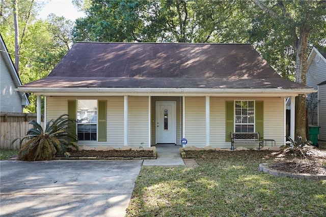 bungalow-style house with a porch and a front lawn