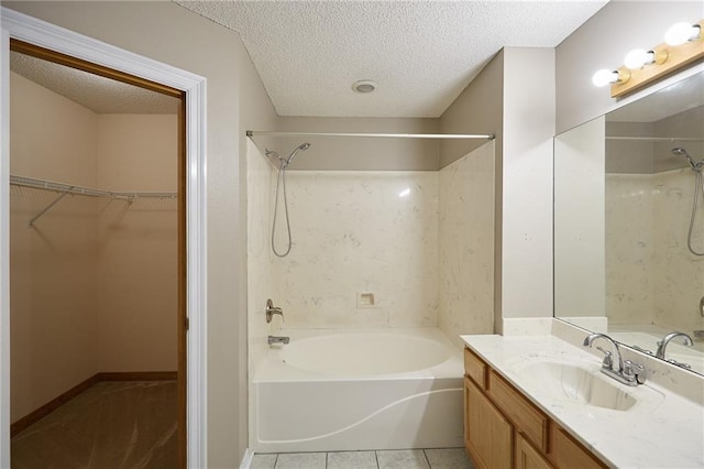 bathroom featuring tub / shower combination, tile floors, vanity, and a textured ceiling