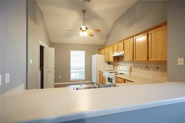 kitchen with white appliances, backsplash, sink, vaulted ceiling, and ceiling fan