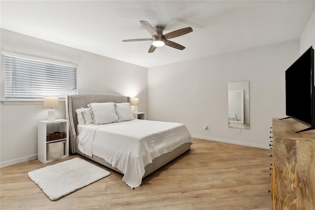 bedroom with light hardwood / wood-style floors and ceiling fan