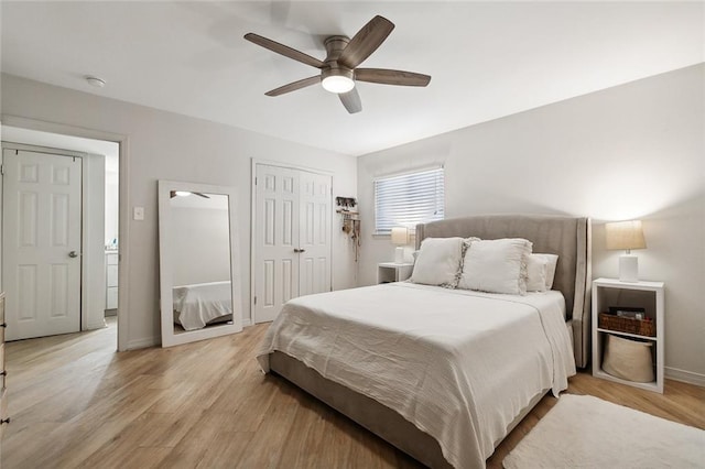 bedroom with light hardwood / wood-style floors and ceiling fan