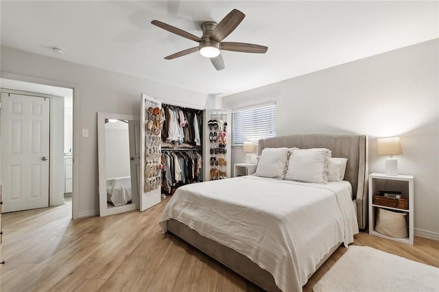 bedroom with a closet, light hardwood / wood-style floors, and ceiling fan