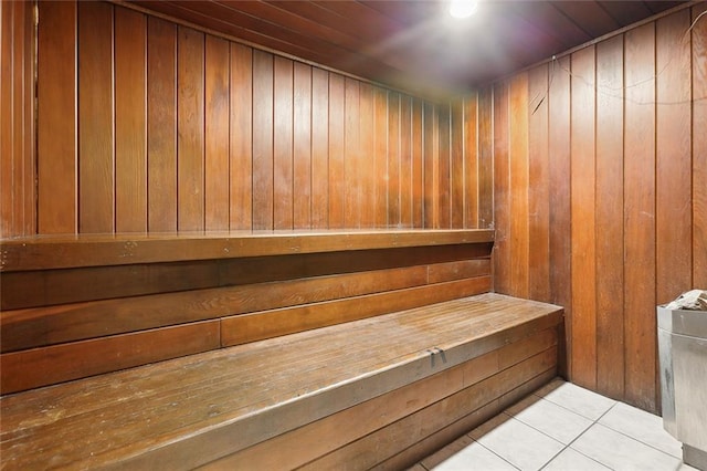 view of sauna / steam room with wooden walls and tile floors