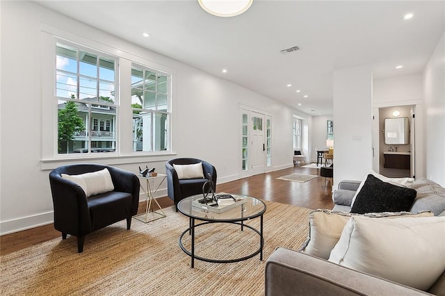 living room with light hardwood / wood-style floors and french doors