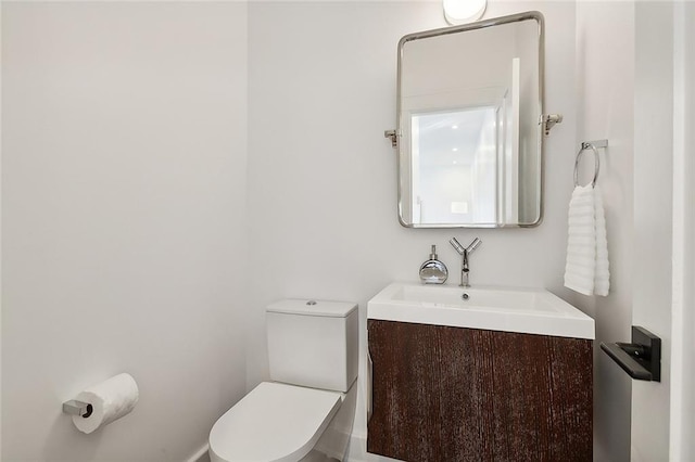 bathroom featuring toilet and large vanity