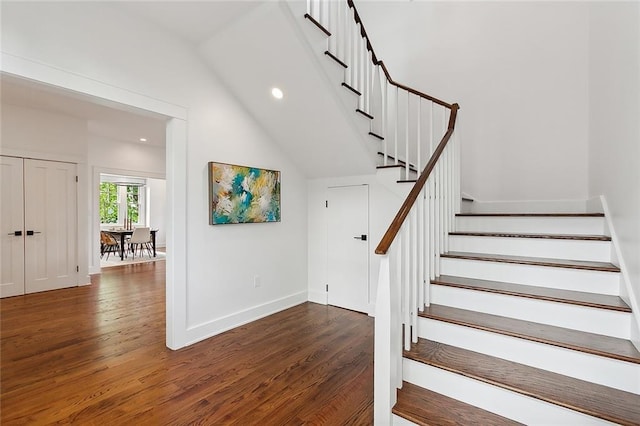 stairs featuring dark wood-type flooring