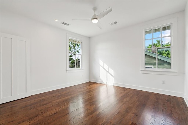 empty room with dark hardwood / wood-style flooring and ceiling fan