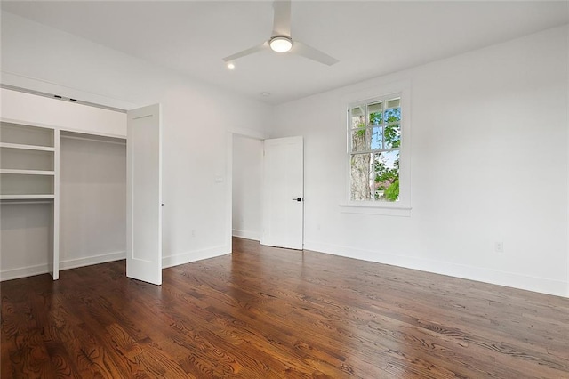 unfurnished bedroom featuring a closet, ceiling fan, and dark wood-type flooring