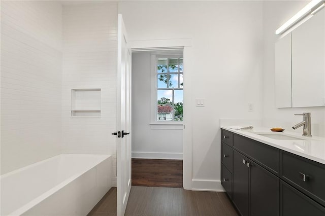 bathroom with shower / bath combination, wood-type flooring, and vanity