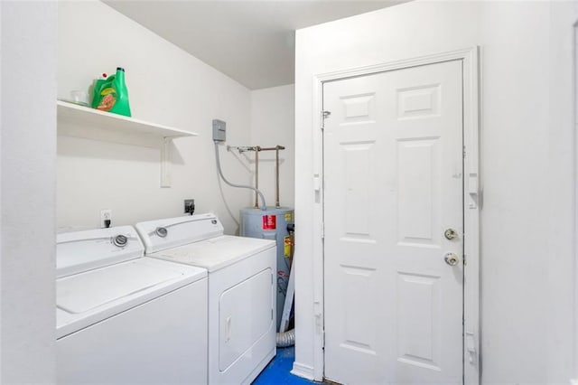 clothes washing area featuring water heater and separate washer and dryer