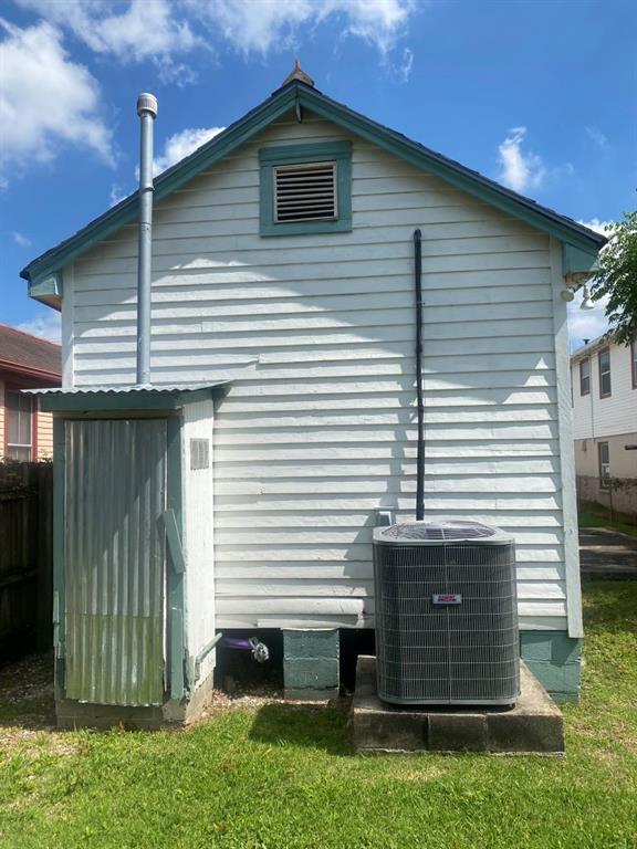 view of side of home with central AC