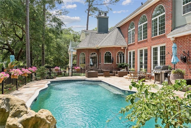 view of swimming pool featuring a patio area, a pergola, and area for grilling