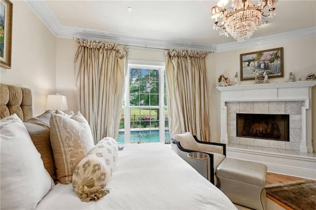 bedroom with access to outside, a tile fireplace, ornamental molding, and hardwood / wood-style floors