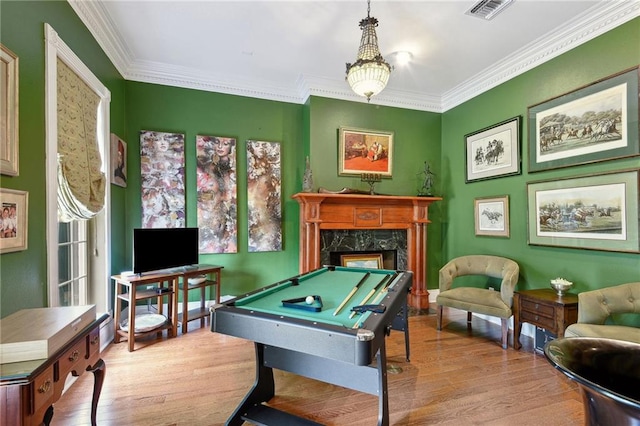 rec room featuring a high end fireplace, billiards, light hardwood / wood-style floors, and crown molding