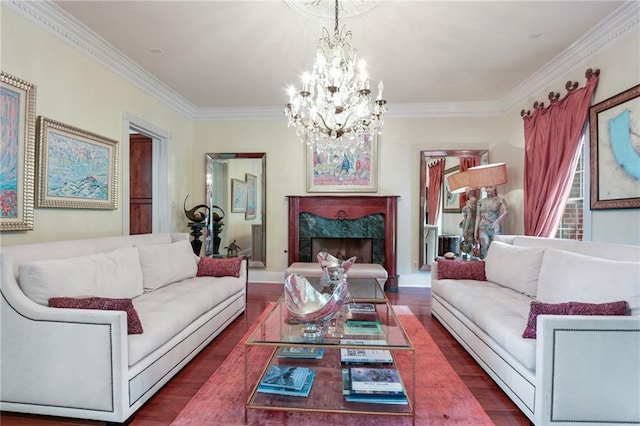 living room featuring a premium fireplace, ornamental molding, wood-type flooring, and an inviting chandelier