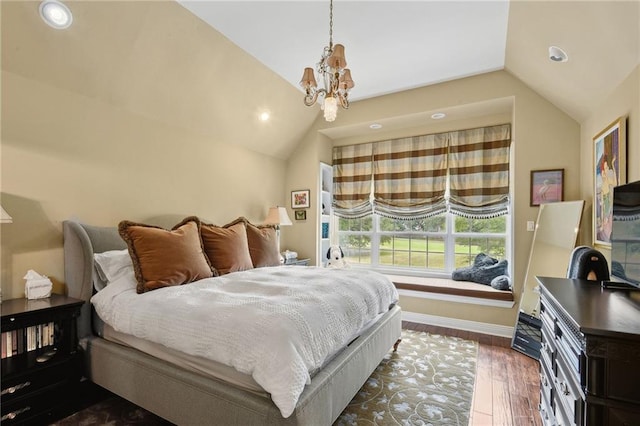 bedroom featuring a notable chandelier, dark wood-type flooring, and vaulted ceiling