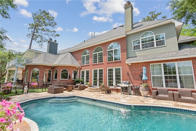 back of property featuring an outdoor hangout area and a patio