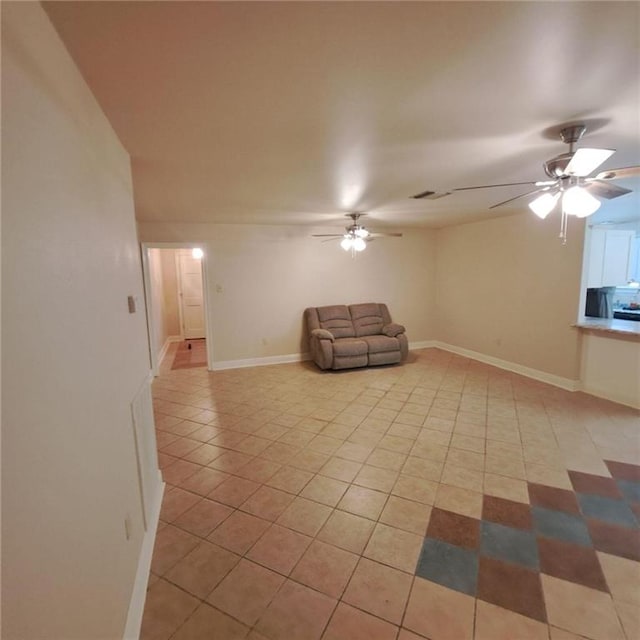 unfurnished living room with ceiling fan and light tile floors