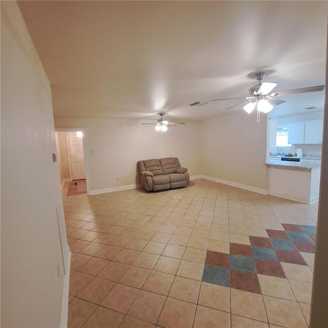 interior space with ceiling fan and light tile flooring