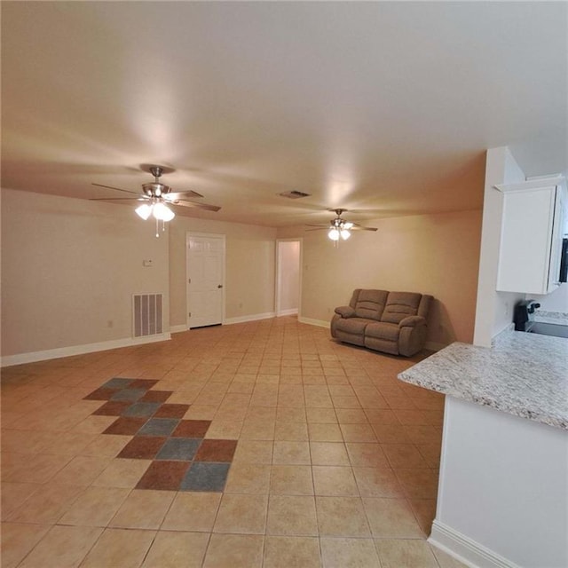 living room featuring ceiling fan and light tile floors