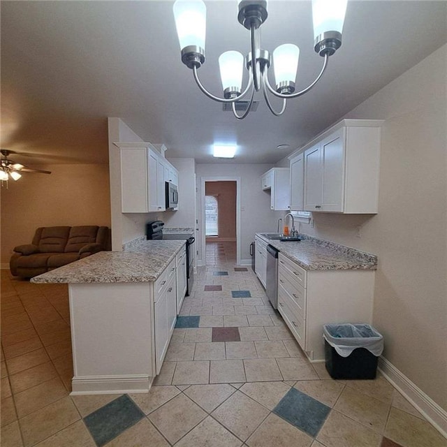 kitchen featuring white cabinetry, light tile floors, and ceiling fan with notable chandelier