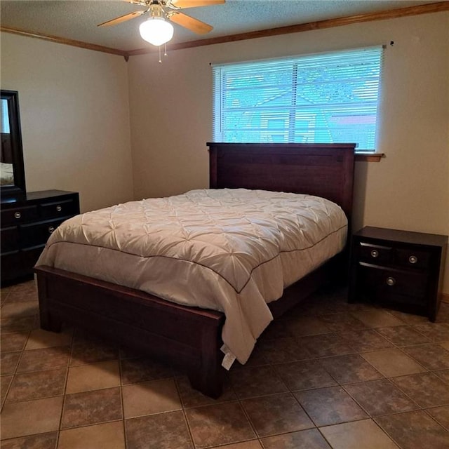 bedroom featuring dark tile flooring, ceiling fan, and ornamental molding