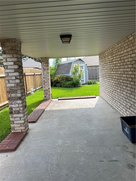 view of patio / terrace featuring a storage unit