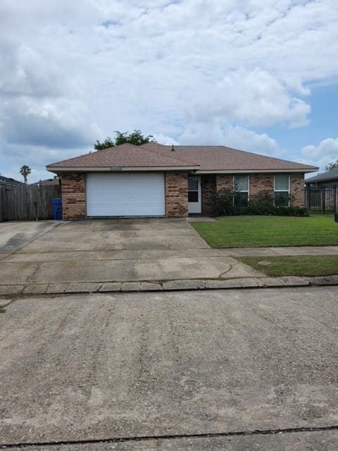 single story home with a front yard and a garage