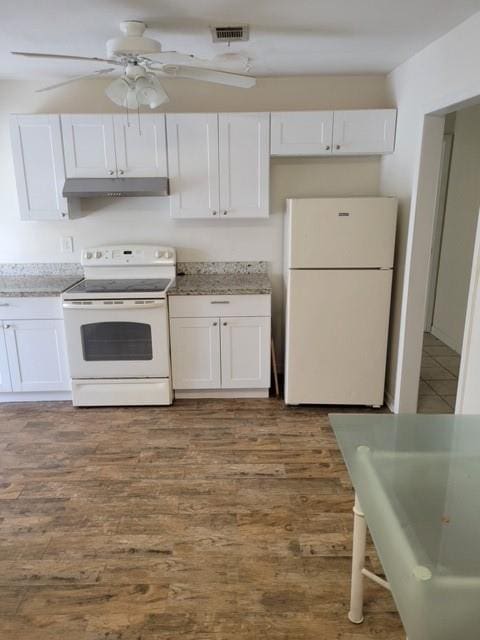 kitchen with white cabinets, wood-type flooring, white appliances, and ceiling fan