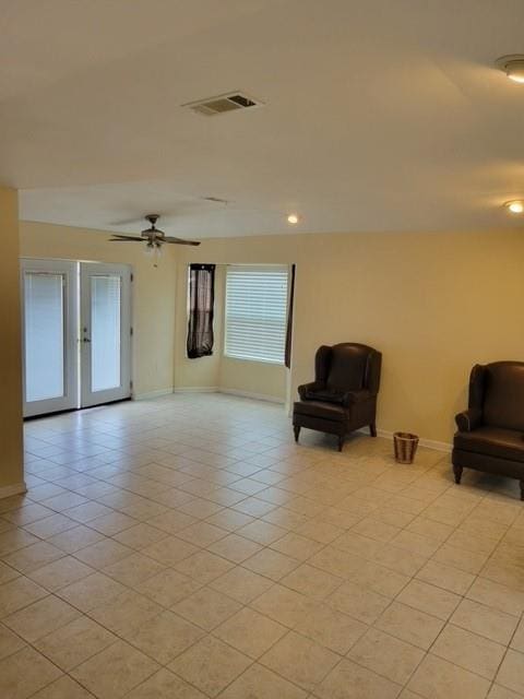 unfurnished room featuring french doors, ceiling fan, and light tile flooring