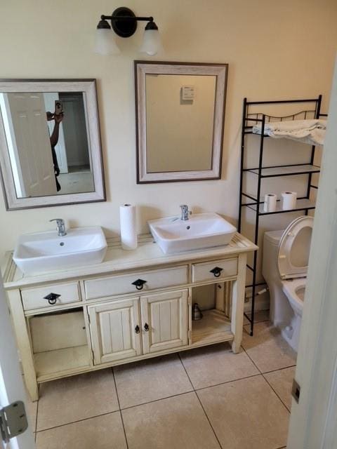 bathroom featuring tile floors and dual vanity