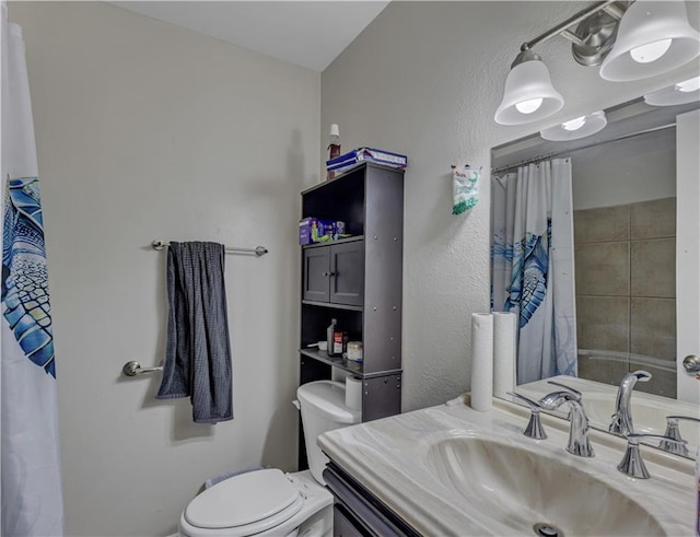 bathroom featuring toilet and vanity