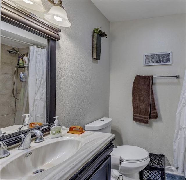 bathroom with vanity with extensive cabinet space and toilet