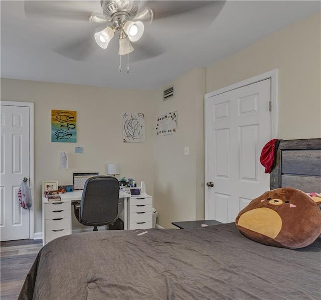 bedroom with wood-type flooring and ceiling fan