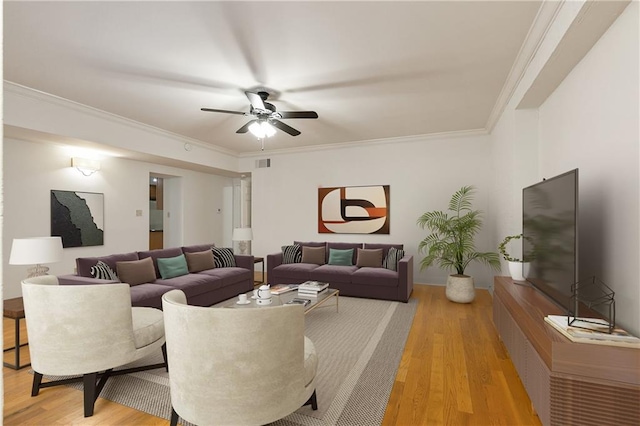 living room with ornamental molding, light hardwood / wood-style flooring, and ceiling fan